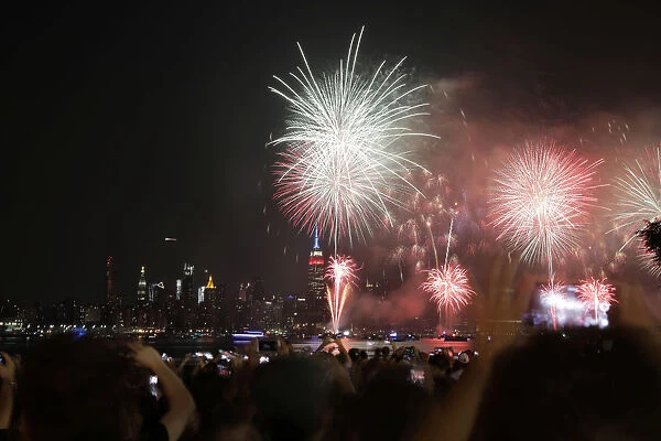 People gather to watch fireworks at the East River State Park in Williamsburg