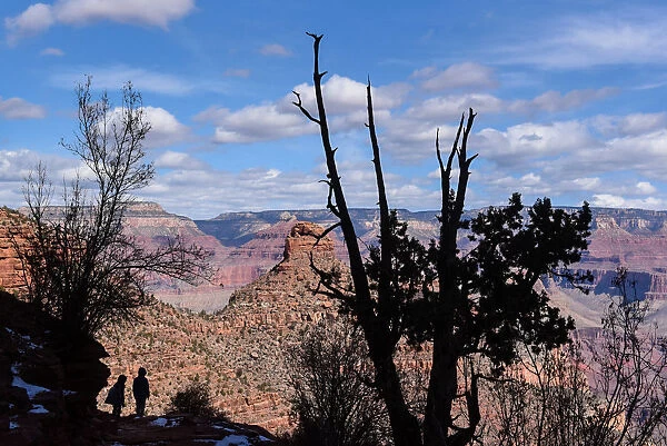 People hike on the Bright Angel Trail in the Grand Canyon near Grand Canyon Village