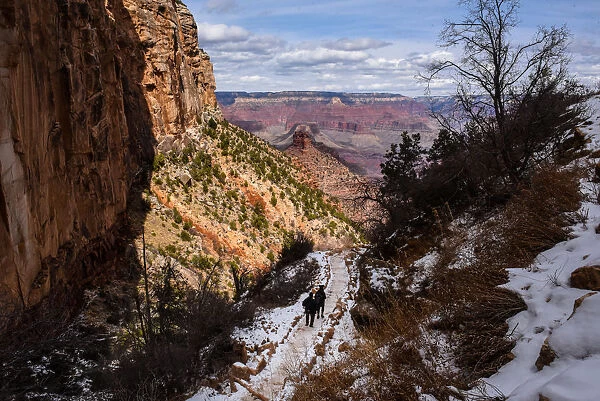 People hike on the Bright Angel Trail in the Grand Canyon near Grand Canyon Village