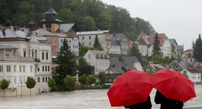 Framed Print : People look at flooded houses after heavy rainfall in the small Austrian city of Steyr