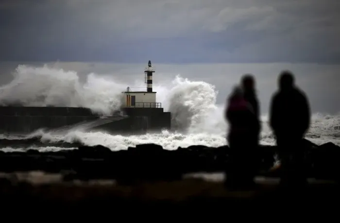 Framed Print : People look at huge waves crashing on the San Esteban de Pravia seafront Framed Print : People look at huge waves crashing on the San Esteban de Pravia seafront