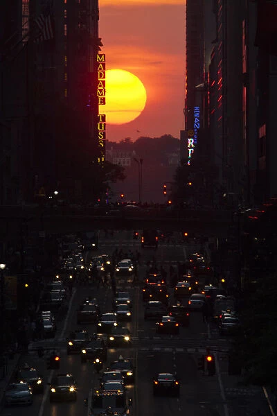 People make their way through 42nd street at sunset, during the Manhattanhenge in