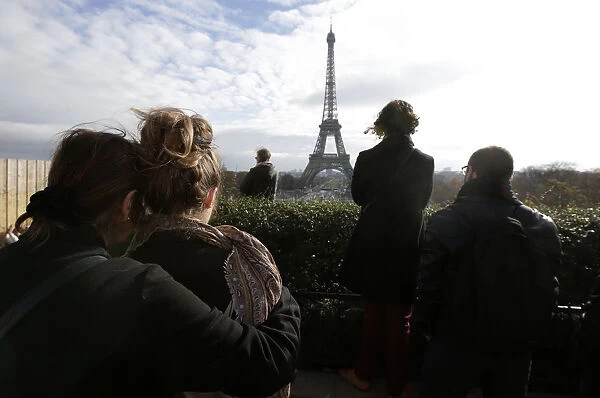 People observe a minute of silence at the Trocadero in front the Eiffel Tower to pay