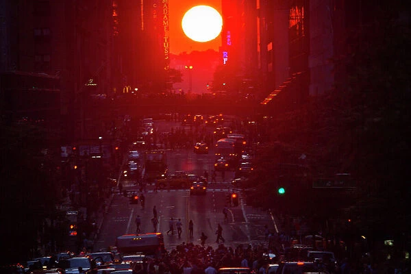 People take photos of the Manhattanhenge phenomenon in New York