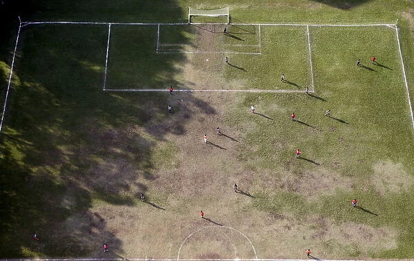 People play soccer in an amateur soccer field in Sao Paulo