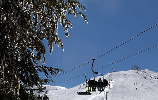 People ride a ski lift at the Mzaar Ski Resort in Kfardebian