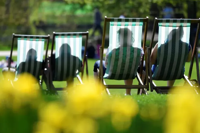 Framed Print : People are silhouetted against the farbric of deckchairs as they enjoy the sunshine in St Framed Print : People are silhouetted against the farbric of deckchairs as they enjoy the sunshine in St