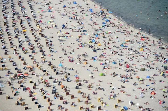 Framed Print : People sitting in beach chairs enjoy the hot sunny weather at the Baltic Sea resort
