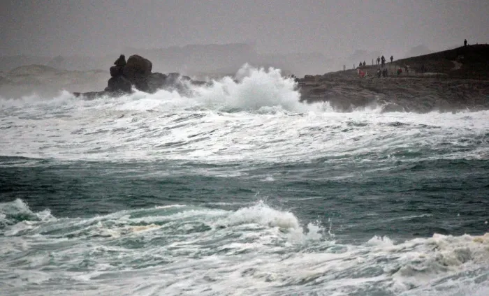 Framed Print : People standing on the Pointe de la Torch peninsula watch waves breaking on the Brittany Framed Print : People standing on the Pointe de la Torch peninsula watch waves breaking on the Brittany