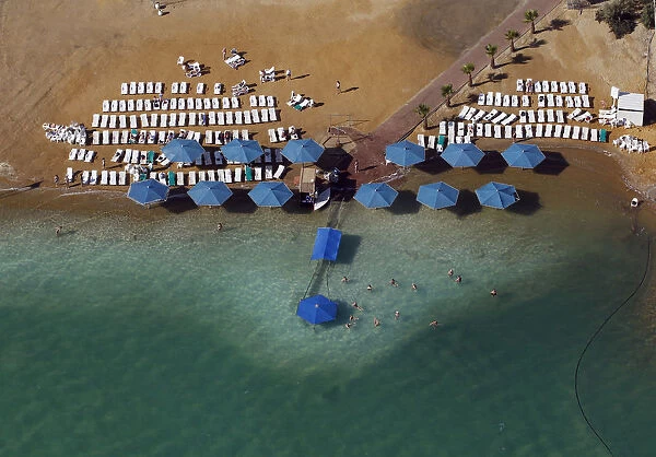 People sunbathe at a public beach in this aerial view of the Dead Sea