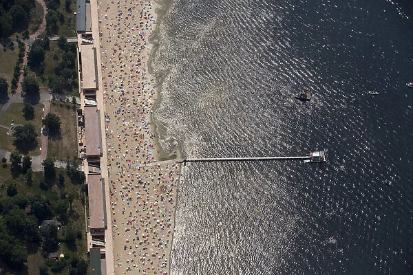 People sunbathe and swim at the beach of Wannsee near Berlin