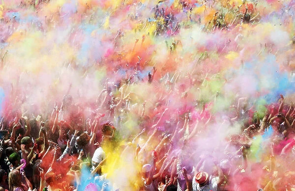People throw coloured powder during the Holi festival in Barcelona