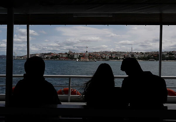 People travel on a ferry over the Bosphorus in Istanbul