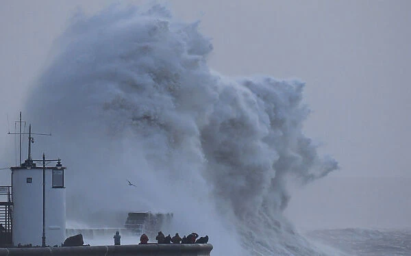 People view large waves and high winds associated with Storm Eleanor as they hit the