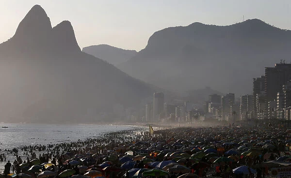 People visit Ipanema beach on a hot day in Rio de Janeiro