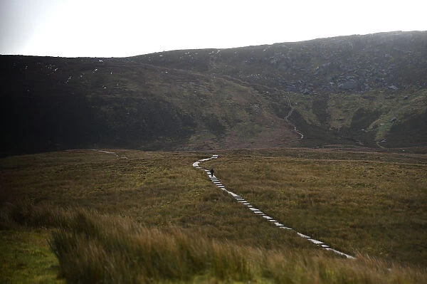People walk on a boardwalk to the border between Ireland and Northern Ireland which
