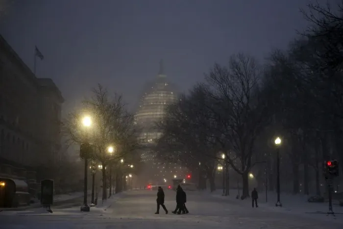 Framed Print : People walk in the falling snow near the U. S. Capitol in Washington