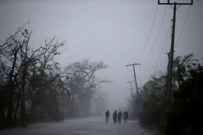 Framed Print : People walk on the road as rain falls during Hurricane Matthew in Les Cayes, Haiti Framed Print : People walk on the road as rain falls during Hurricane Matthew in Les Cayes, Haiti