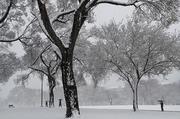 People walk through the snow near the National Mall in Washington