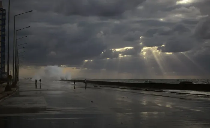 Framed Print : People walk as waves crash on the El Malecon seafront boulevard Framed Print : People walk as waves crash on the El Malecon seafront boulevard