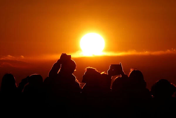 People watch the first sunrise on New Years Day at Roppongi Hills observation deck