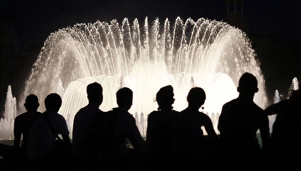 People watch the Font Magica de Montjuic (Magic Fountain of Montjuic) show in Barcelona