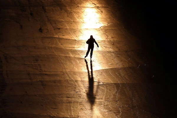 A person casts a shadow while skating on the Rideau Canal in Ottawa