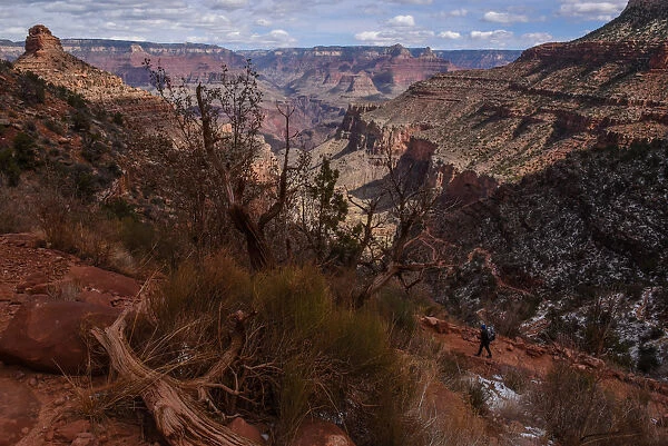 A person hikes on the Bright Angel Trail in the Grand Canyon near Grand Canyon Village