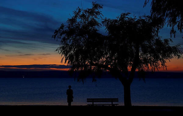 A person is seen during sunset at lake Neusiedl in Podersdorf