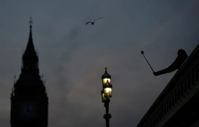 Framed Print : A person takes a photograph on Westminster Bridge at dusk in central London Framed Print : A person takes a photograph on Westminster Bridge at dusk in central London