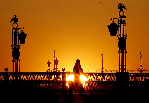 A person walks across a bridge in central St Petersburg