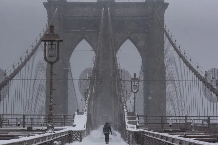 Framed Print : A person walks over the Brooklyn Bridge during winter storm Niko in New York City Framed Print : A person walks over the Brooklyn Bridge during winter storm Niko in New York City