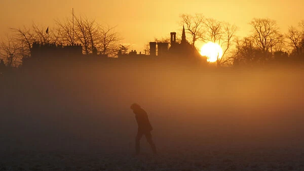 A person walks during sunrise in Knutsford
