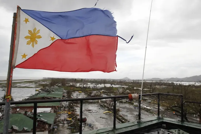 Framed Print : A Philippine flag flutters atop the control tower of a damaged airport after super Framed Print : A Philippine flag flutters atop the control tower of a damaged airport after super