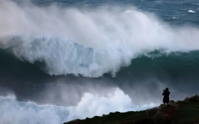 Framed Print : A photographer takes pictures of waves breaking on the Brittany coast at Audierne in