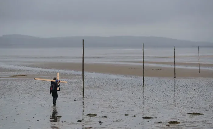 Framed Print : A pilgrim walks accross a tidal causeway on the final leg of the Northern Cross Framed Print : A pilgrim walks accross a tidal causeway on the final leg of the Northern Cross