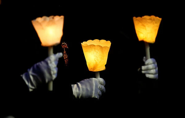 Pilgrims hold candles during the Corpus Domini procession led by Pope Francis at the