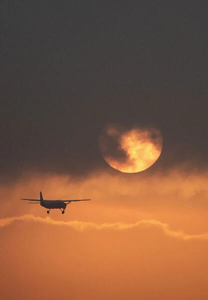 Plane flies during sunrise in the early hours in Bogota