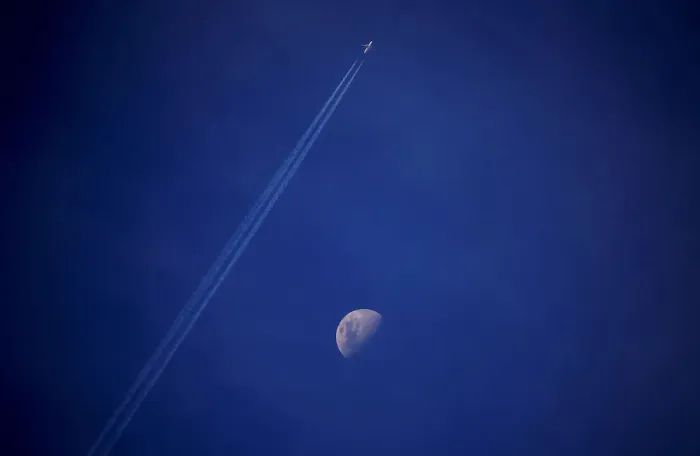 Framed Print : A plane leaves a vapor trail as it flies past the moon above the town of Gunnedah Framed Print : A plane leaves a vapor trail as it flies past the moon above the town of Gunnedah