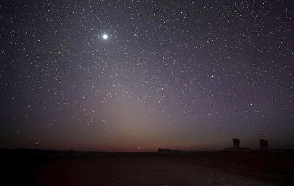 The planet Venus is seen in the night sky over rocks in the White Desert north of