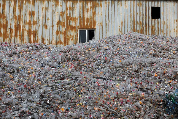 Plastic bottles are stocked to be recycled at the Weeco plastic recycling factory at the