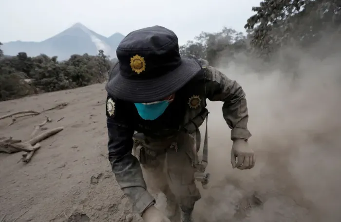 Framed Print : A police officer stumbles while running away after the Fuego volcano spew new pyroclastic Framed Print : A police officer stumbles while running away after the Fuego volcano spew new pyroclastic
