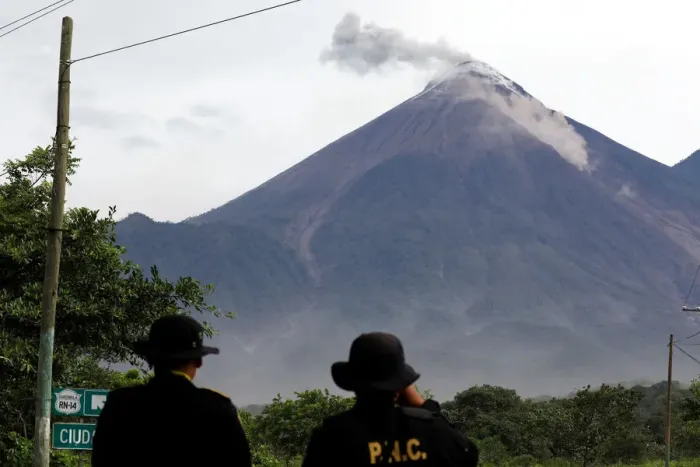 Framed Print : Police officers observe a lahar flowing down from the Fuego volcano at El Rodeo in