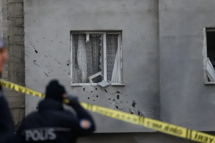Framed Print : A policeman stands in front of a building which was damaged after a rocket fired Framed Print : A policeman stands in front of a building which was damaged after a rocket fired