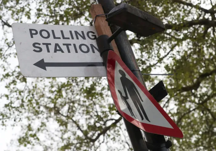 Framed Print : A polling station sign is attached to a lamp post in central London Framed Print : A polling station sign is attached to a lamp post in central London