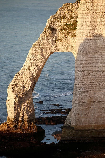 The Porte d Aval, a famous arch of the Etretats cliffs, is seen during sunset