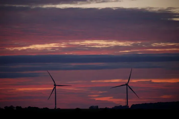 Framed Print : Power-generating windmill turbines are pictured during sunset at a wind park in Framed Print : Power-generating windmill turbines are pictured during sunset at a wind park in