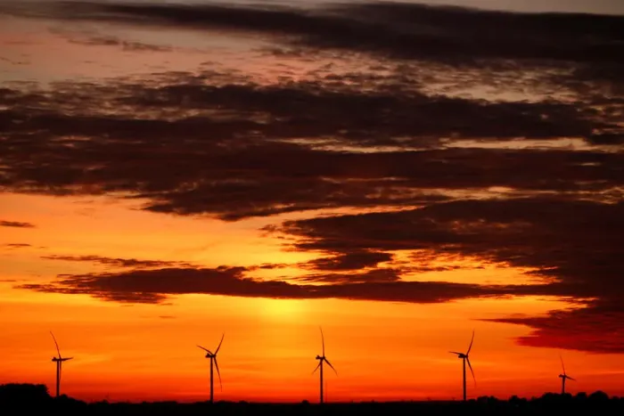 Framed Print : Power-generating windmill turbines are pictured during sunset at a wind park in Framed Print : Power-generating windmill turbines are pictured during sunset at a wind park in