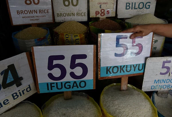Prices of different variety of rice are seen in a public market in Kamuning