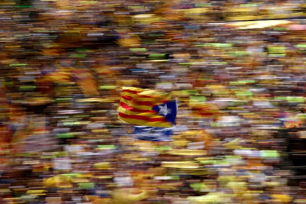 A pro-independence supporter waves a Catalan separatist flag, known as Estelada